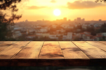 Wall Mural - Wooden table against blurred sunset city backdrop.