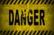 © Philip - WARNING danger sign word text as stencil with yellow and black stripes painted over concrete wall cement texture wide banner background. Concept image for caution, dangerous area and hazard.