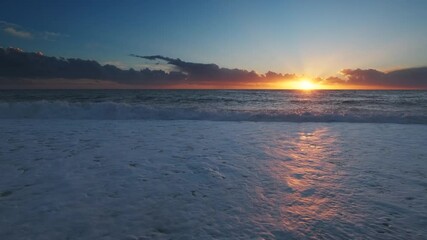 Wall Mural - stunning sunset over sea with vibrant colors reflecting on the water at the beach, 4k