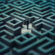 © awatch - businessman walking inside of stone maze, business concept for solving problems, seeking the solution