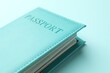 © New Africa - Passport in bright cover on light blue background, closeup