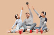 © Pixel-Shot - Children taking game pad away from their father on beige background