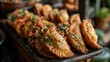 © M_H_L - A tray of golden empanadas topped with fresh salsa and herbs, showcasing delicious cuisine.