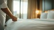 © svastix - A hotel room features a well-made bed with crisp linens and soft lighting, evoking feelings of comfort, cleanliness, and welcoming hospitality in a serene setting.