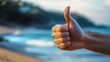 © Юлия Гриб - Person Giving a Thumbs up Gesture on a Beach With Waves and Shoreline in the Background During Daytime