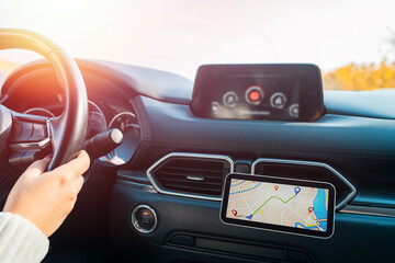 A female driver using a phone navigator in the car,