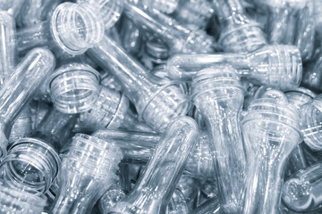 Poster - pile plastic transparent capsules preform of press molds for production of plastic bottles by the method of hot blowing. tubes are transparent industrial background