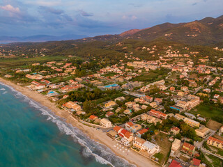 Wall Mural - Aerial view of a coastal town at sunset.