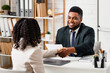 © Prostock-studio - Happy personnel manager and young job applicant shaking hands at modern company office