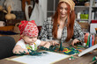 © fotodrobik - A Creative Mother and Her Child Engaging Together in Fun and Artistic Art Activities