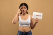 © Prostock-studio - A young Indian woman shows concern while holding a calendar with marked dates, have menstruation delay