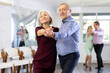 © JackF - Active elderly people attend dance lessons for amateurs and learn to dance tango in their free time