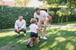 © ADDICTIVE STOCK - Gay couple teaching their son to ride a bicycle in the garden