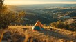 © siyons - Colorful Tent Set Against a Scenic Hillside Landscape