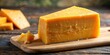 © Nasnunt - Close-up of a portion of cheddar cheese, cheddar, cheese, dairy, dairy product, food, yellow, snack, close-up, texture