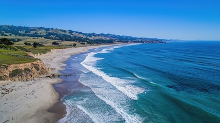 Aufkleber - Discover the serene beauty of a pristine sandy beach merging with gentle ocean waves. This aerial image captures a colorful coastline under a clear blue sky.