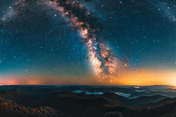 Wall Mural - Stunning night sky with the Milky Way stretching across a starry backdrop. Ideal for nature and astronomy themes.