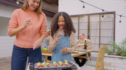 Wall Mural - Multiracial family having fun and enjoying party outdoors in garden. 