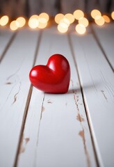 Wall Mural - Red heart rests on white wood with blurred lights