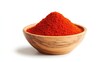 © P.G - Close-up of vibrant red chili powder in a small wooden bowl, with a clean white background highlighting its bold color and texture