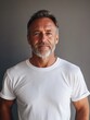 © Elena - Grey-haired bearded man in white t-shirt
