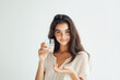© kazakova0684 - young beautiful woman holding a transparent glass of water on a white background, studio photo