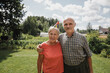 © Westend61 - Portrait of happy senior couple standing in the garden