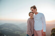 © Westend61 - Switzerland, Grosser Mythen, portrait of happy young couple standing in mountainscape at sunrise