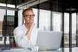 © Westend61 - Businessman with laptop on desk in office thinking