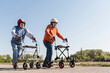 © Westend61 - Two old friends wearing safety helmets, competing in a wheeled walker race