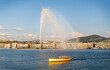© ADDICTIVE STOCK - Jet d’Eau and Rainbow Over Lake Geneva With a Yellow Boat