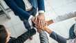 © Chenda - over head view of business workplace solidity standing putting hands together compassion working colleagues diverse office