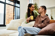 © LIGHTFIELD STUDIOS - A lovely couple shares warm moments in their decorated home during the holiday season.