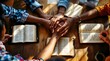 © Stock Photo Zone - Diverse Group of People United in Prayer, Hands Overlapping on Open Bibles, Warm Sunlight Streaming Through Window