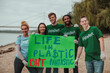 © bernardbodo - Volunteers showing a sign against plastic pollution