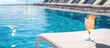 © CreativeBro - Refreshing cocktail on a white sunbed beside a pristine swimming pool under a clear blue sky ideal for tropical relaxation and leisure.
