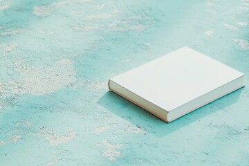 Poster - Minimalist Aesthetic A Pristine Book on Textured Turquoise Surface