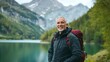 © Adi - Happy older man standing in nature park enjoying natural park landscape. Smiling mature active traveler exploring camping tourism nature lake and mountains travel journey feeling freedom, with copy sp