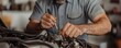 © ParinApril - A mechanic works on an engine, using tools to repair and maintain vehicle components in a well-lit workshop.