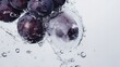 © Nadin Faust - Juicy grapes collide with water droplets, creating a dance of bubbles in a cool ambiance. This moment captures the essence of freshness and deliciousness in every splash.
