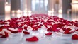© Sonya - Room adorned with numerous red and white petals atop white floor, beside a row of flickering candles