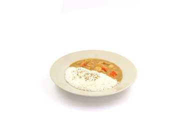 Wall Mural - Japanese  cuisine rice and curry sauce with potatoes and carrots in ceramic dish on white background. Japanese food style