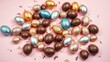 © GiftedFrames - A delicate scattering of chocolate, silver, and gold Easter eggs on a soft pink background