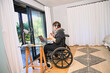 © Caia Image - Woman in wheelchair using laptop
