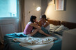 © Marko Geber - Lesbian couple embracing in bed at home