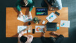 © InfiniteFlow - Top view of business team attend meeting while prepare working and analyzing data. Group of diverse people planning creative and working on start up project while team joining conference. Convocation.