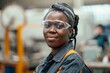 © CojanAI - Portrait of a happy African American female employee working at a factory