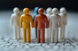 © Fotograf - A group of toy people standing in a line on a shelf or table