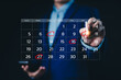 © Supatman - Calendar agenda appointment meeting schedule concept. Businessman using pen to writing circle red mark on virtual calendar. Planning Organizer, Time management, Manage event time for effective work.