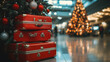 © britaseifert - A festive scene in an airport, featuring stacked red suitcases next to a decorated Christmas tree with red and silver ornaments